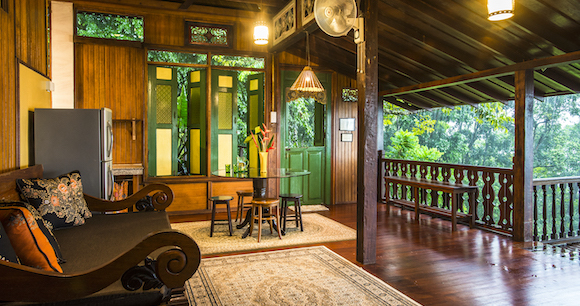 A living room in a house with a wooden floor and a couch.